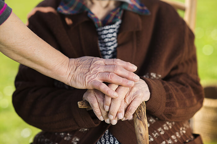 old woman holding a cane