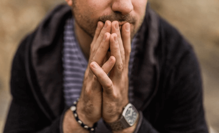 Man sitting with his hands together