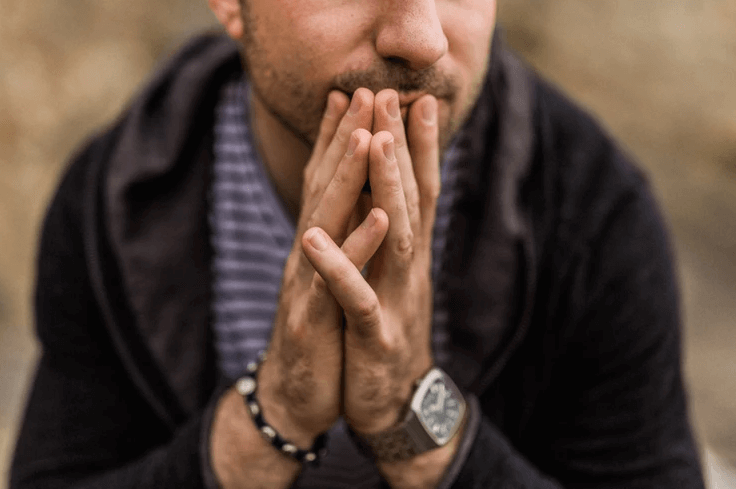 Man sitting with his hands together