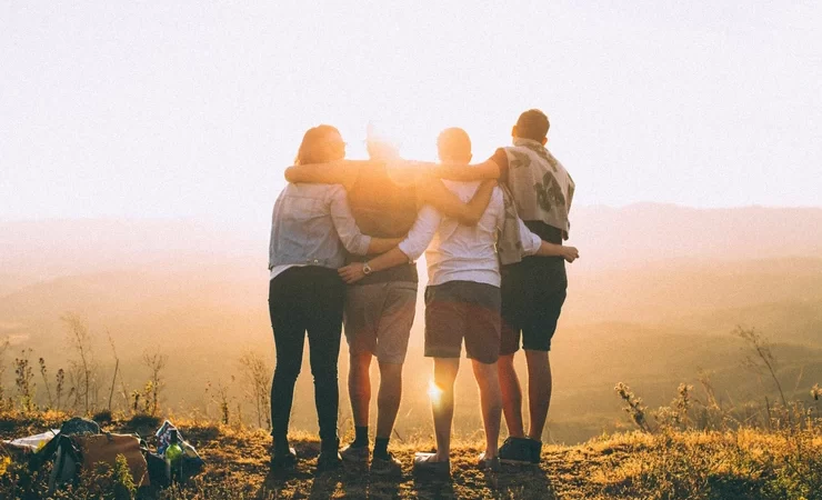 group of friends looking over a mountain