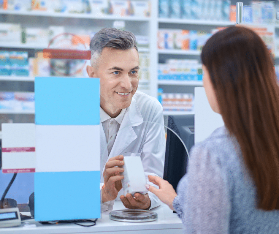 Pharmacist behind the counter advising a patient on take-home Suboxone to treat opioid use disorder.