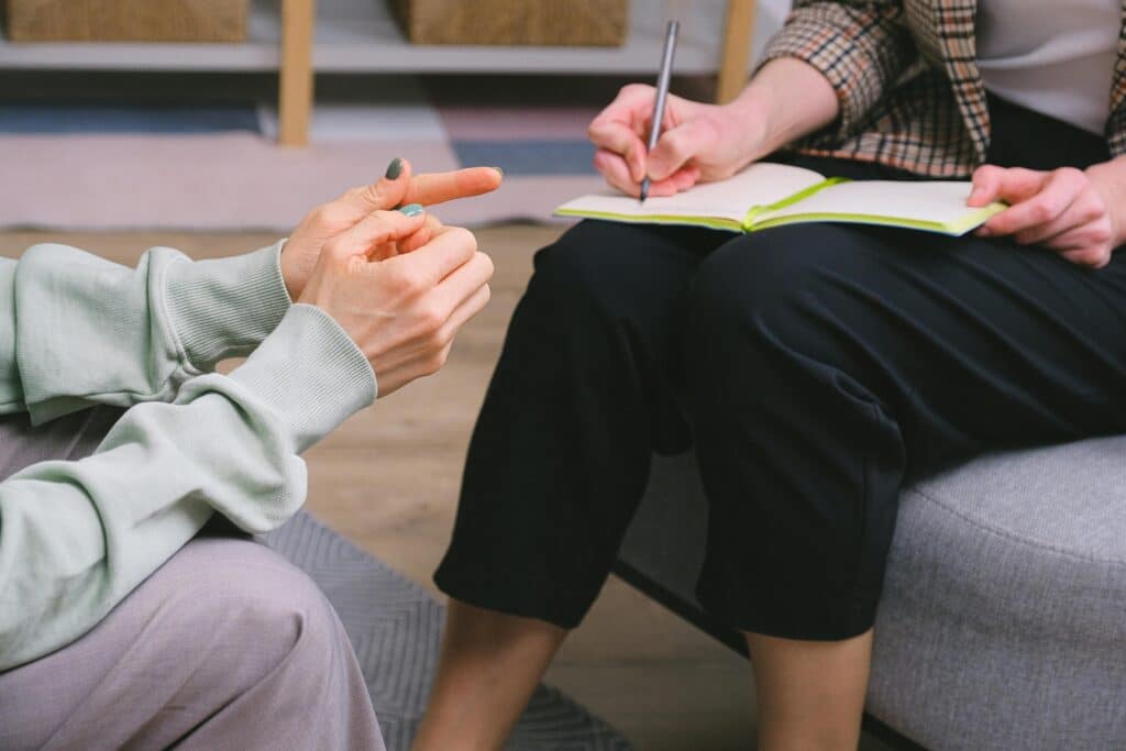 doctor writing prescription to patient 