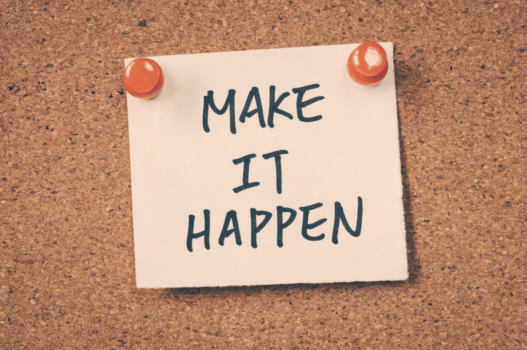 A sticky note pinned to a corkboard with the message 'MAKE IT HAPPEN' symbolizing the importance of taking proactive steps and believing in one's ability to achieve lasting recovery.