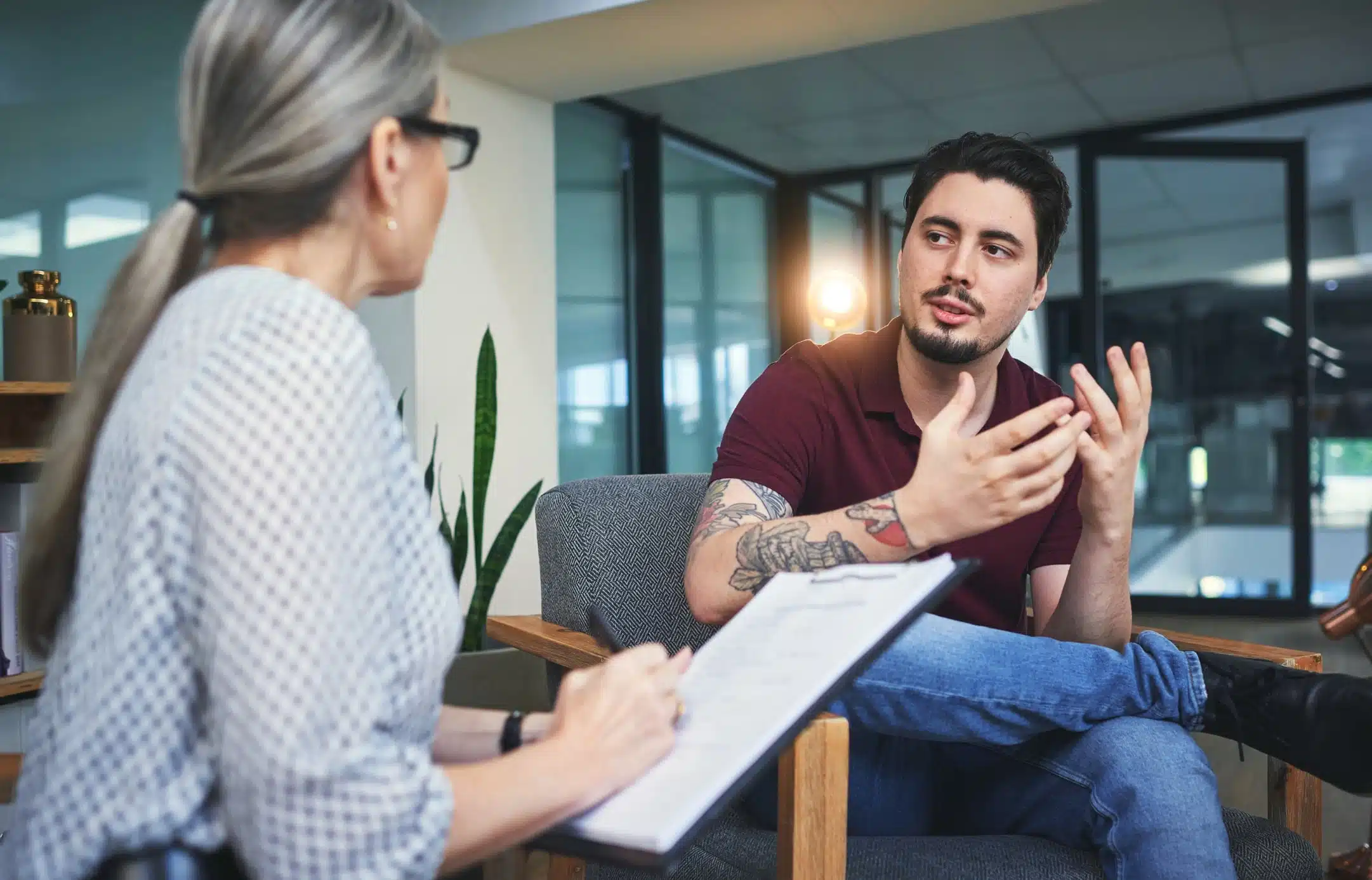 Shot of a young man having a therapeutic session with a psychologist